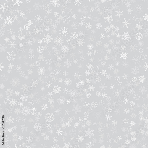 seamless pattern from white snowflakes on the grey background. Texture for cards, greeting, Christmas, new year, holiday, party