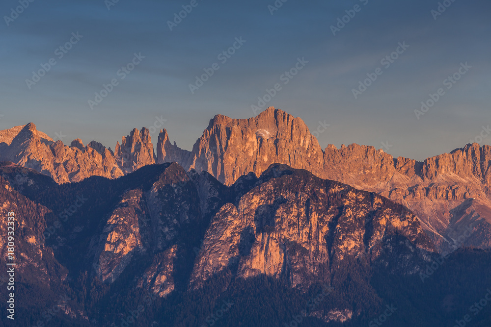 Autumnal sunset light on Catinaccio and Torri del Vaiolet peaks, Dolomites, Alto Adige/South Tyrol, Italy