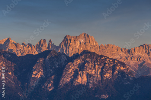 Autumnal sunset light on Catinaccio and Torri del Vaiolet peaks, Dolomites, Alto Adige/South Tyrol, Italy