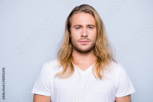 Photos Portrait of handsome young serious confident young guy with blonde long hair in