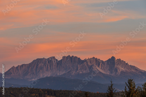 Amazing colorful clouds during autumnal sunset over Latemar summit  Alto Adige South Tyrol  Italy