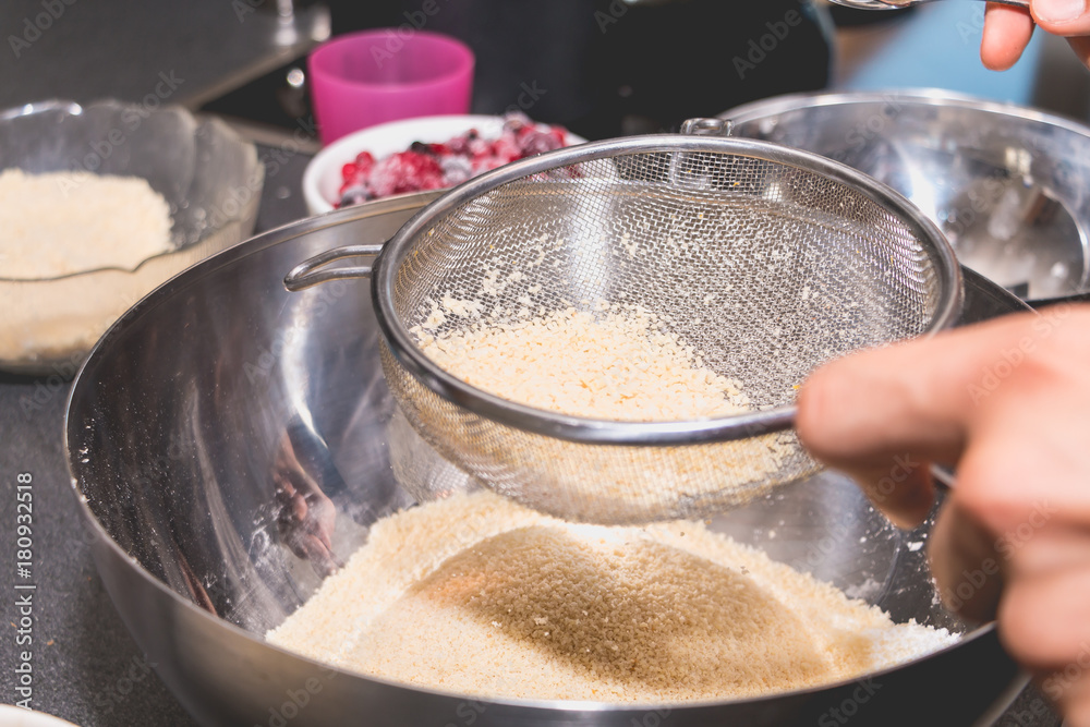 cook mixes and sieves almond powder in flour cook mixes and sieves almond powder in flour