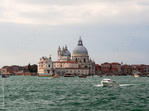 View of the dome and Santa Maria della Salute in Venice from the water with a power boat in the foreground