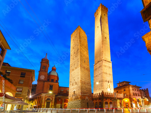 Two Towers, Asinelli and Garisenda, both of them leaning, symbol of Bologna, statue of San Petronius and Church of Saints Bartholomew and Gaetano in the morning, Bologna, Emilia-Romagna, Italy