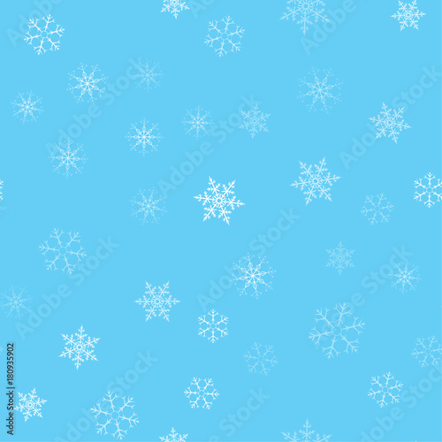Christmas abstract background from white snowflakes on blue. Seamless pattern for design cards, posters, greeting for the new year.