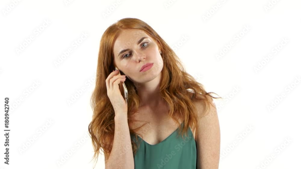 Redhaired girl talking on the phone. White background Redhaired girl talking on the phone. White background