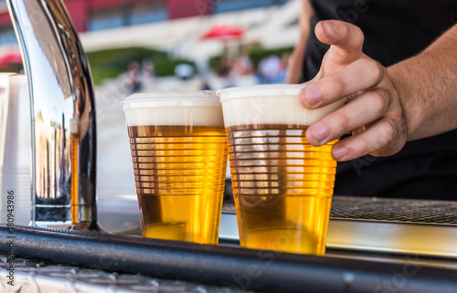 Serving cold beer at a street food market photo