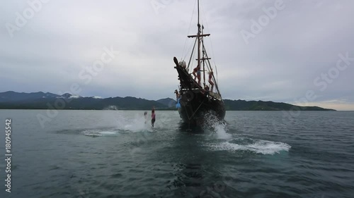 Tourists jump off yacht pirate ship on vacation.