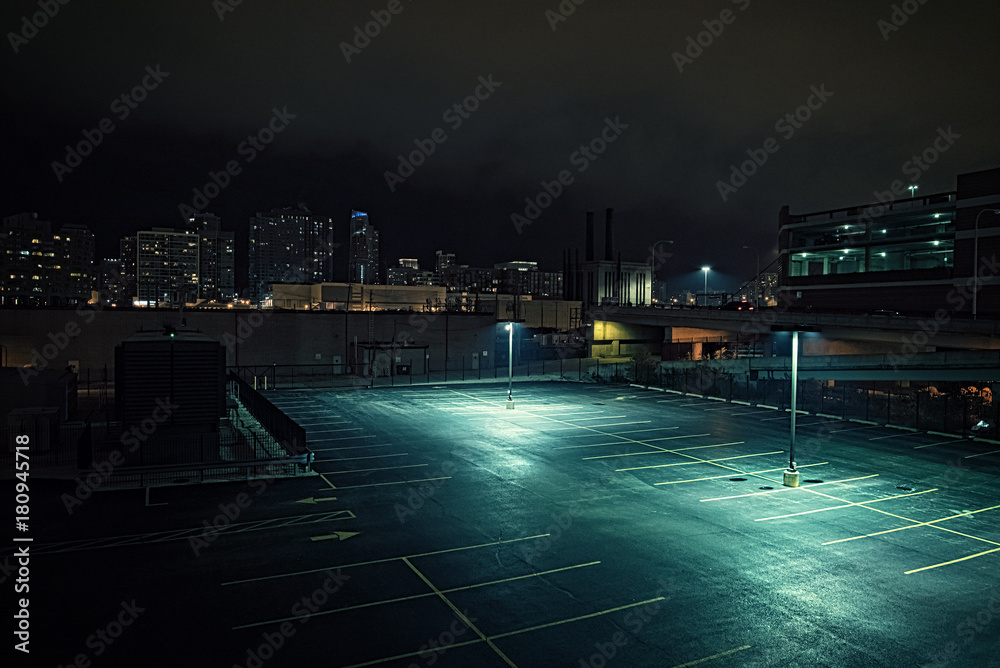 Big deserted urban city parking lot and garage at night in Chicago.