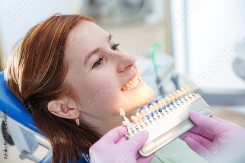 dentist chooses color of tooth enamel in patient