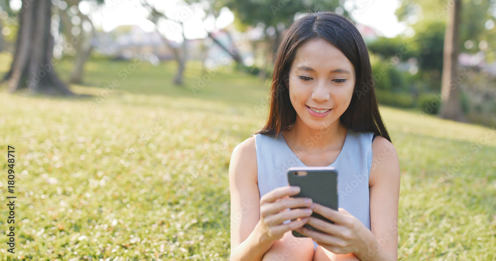 Woman sending sms on mobile phone