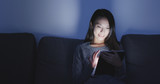 Asian woman use digital tablet at night