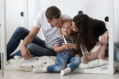 Young family  mother  father and daughter are playing together. Family  relationships  family values  portrait.