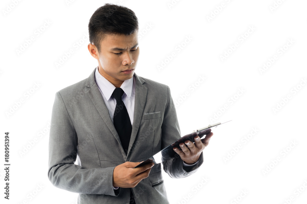 Portrait of a young business man reading annual report. Isolated on white background Portrait of a young business man reading annual report. Isolated on white background