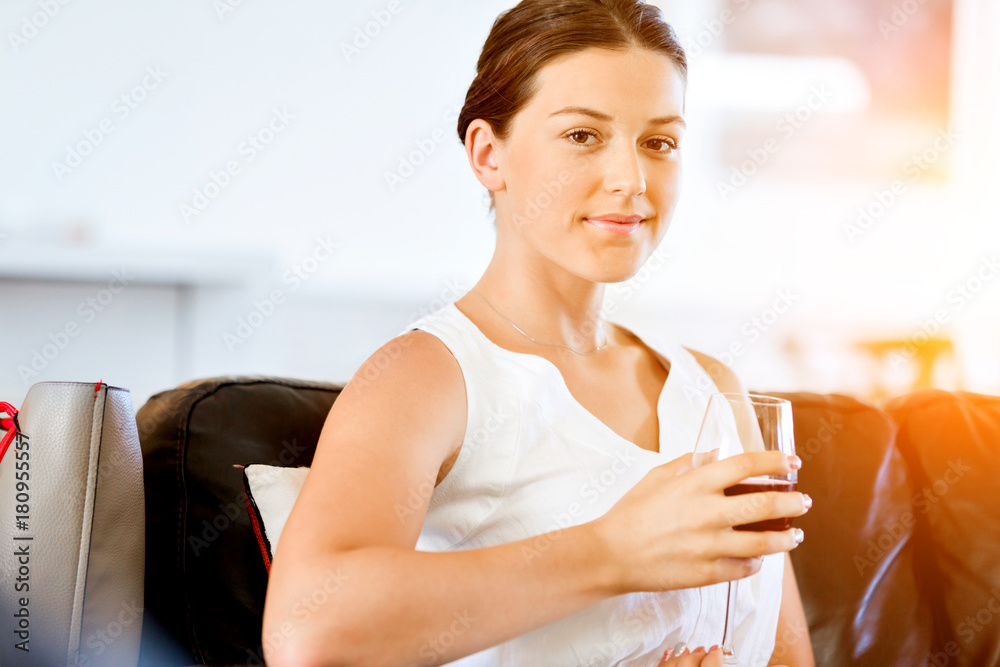 Beautiful young woman holding glass with red wine Beautiful young woman holding glass with red wine