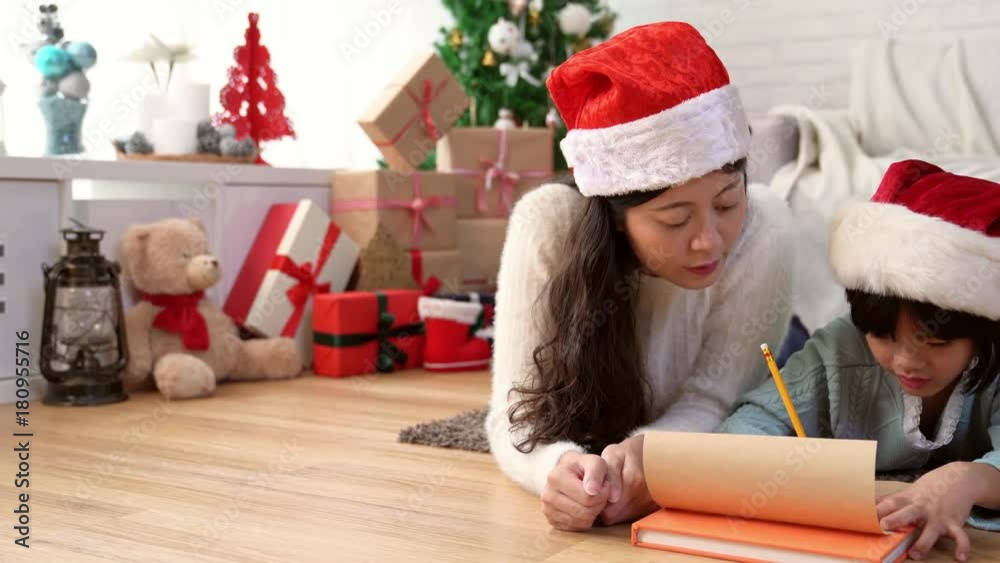 small child writes the letter with her mother small child writes the letter with her mother