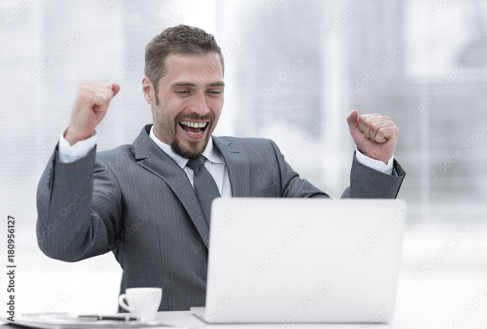closeup.happy businessman sitting in front of an open laptop. closeup.happy businessman sitting in front of an open laptop.
