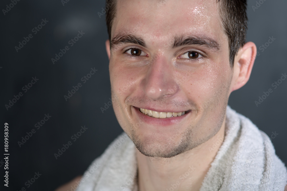 Obraz premium Portrait of young man with towel in shower