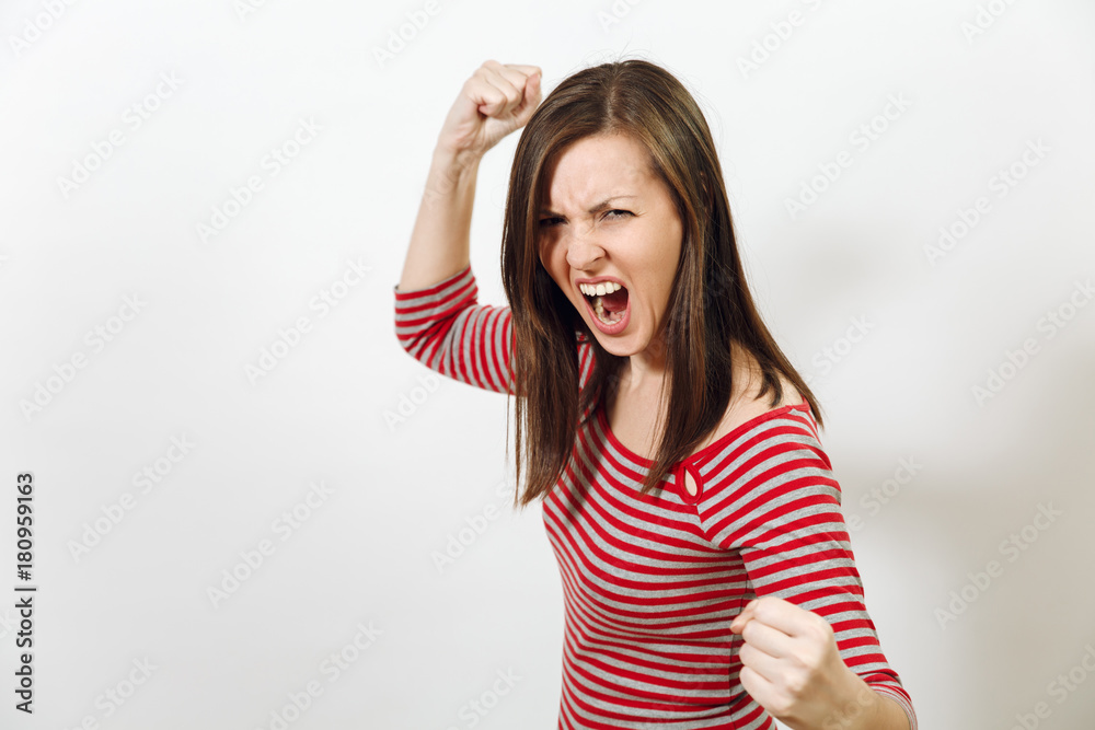 Pretty European young angry brown-haired woman with healthy clean skin, dressed in casual red and grey clothes, screaming, swearing and waving her arms, on a white background. Emotions concept. Pretty European young angry brown-haired woman with healthy clean skin, dressed in casual red and grey clothes, screaming, swearing and waving her arms, on a white background. Emotions concept.