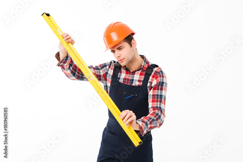 Full length portrait of a concentrated young male builder