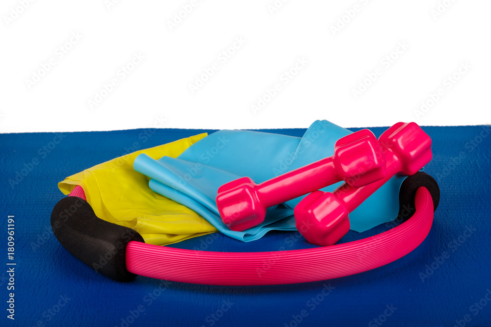 Pilates Circle, Dumbbell, Band on Blue Yoga Mat Pilates Circle, Dumbbell, Band on Blue Yoga Mat