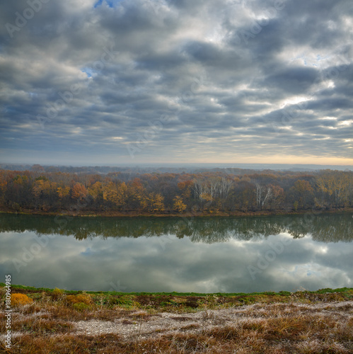Autumn landscape on the hills of the River Don. View of the pond on a background of cloudy sky ..