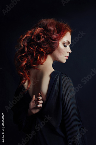 Portrait of redhead sexy woman with long hair on black background. Perfect girl with the blue eyes, nice clean skin, beautiful natural makeup, red hair photo