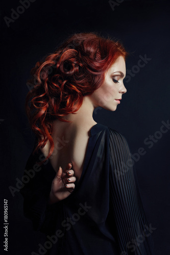Canvas Print Portrait of redhead sexy woman with long hair on black background