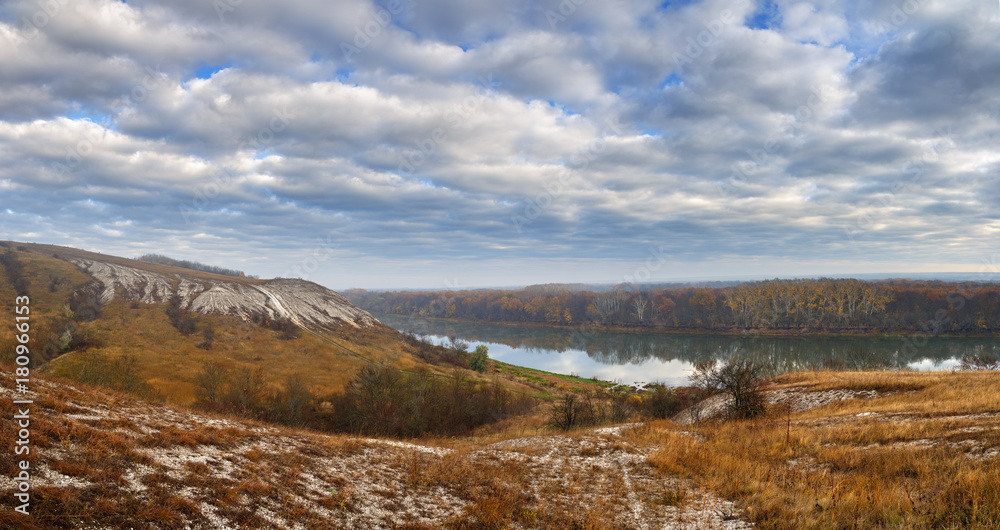 Autumn landscape. Cretaceous hills of the Don River. View on the pond on a background of cloudy sky.
