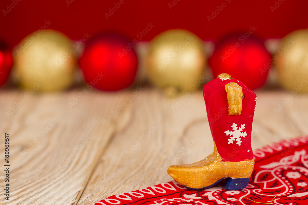 Cowboy boot on christmas wood holiday background