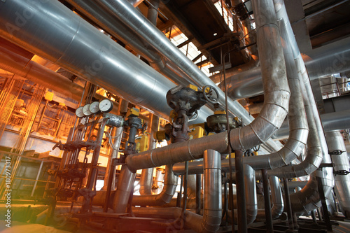 Equipment, cables and piping as found inside of a modern industrial power plant