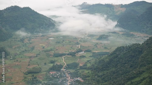 Mountain valley, rural village and sea of mist in morning. Landscape view from Phu Chi Fa, Chiang Rai ,Thailand
