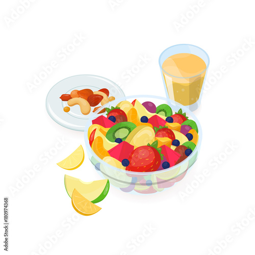 Bowl of salad made of fresh exotic fruits, glass of orange juice and nuts lying on plate isolated on white background