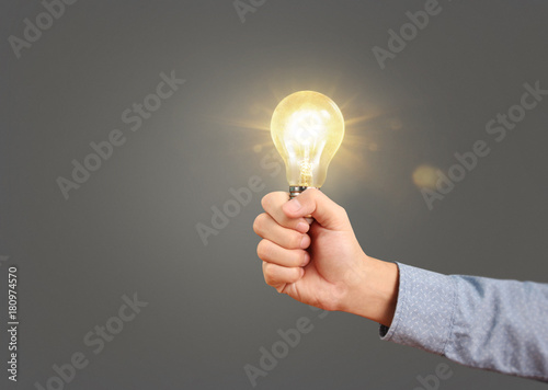 holding lightbulb in  hand