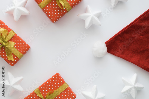 Christmas and New Year holiday composition with gift boxes, santa hat, ribbons, stars on the white background. Top view, flat lay. Copyspace. © tumana_net