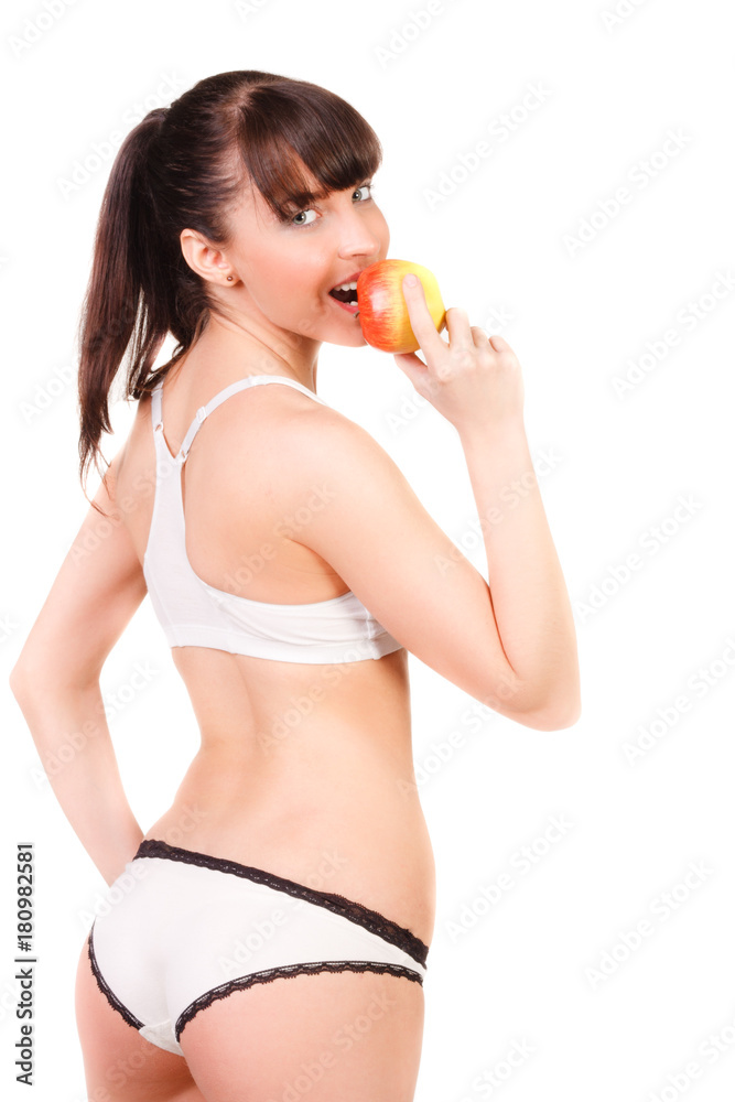 beautiful young woman with slim body in underwear eating an apple isolated beautiful young woman with slim body in underwear eating an apple isolated