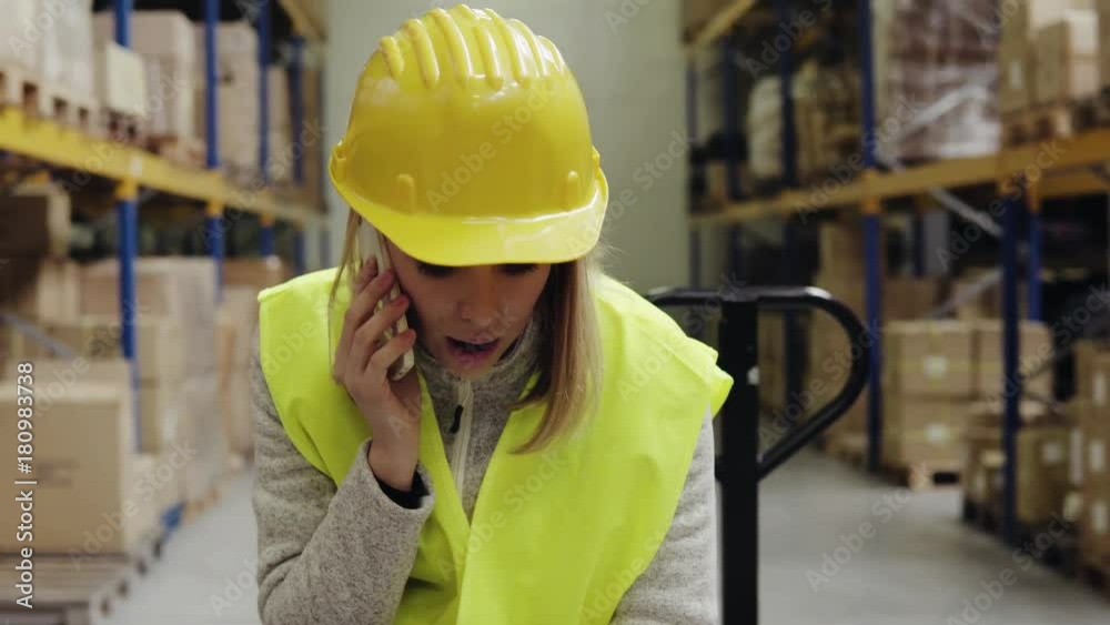 Female warehouse worker with smartphone. Female warehouse worker with smartphone.