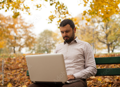 Portrait of handsome man using laptop