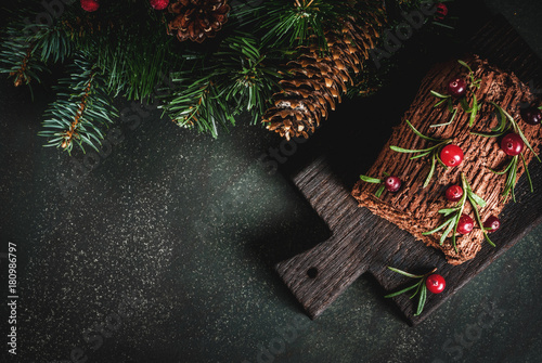 Canvastavla Traditional Christmas dessert, Christmas yule log cake with chocolate cream, cranberry and rosemary twigs