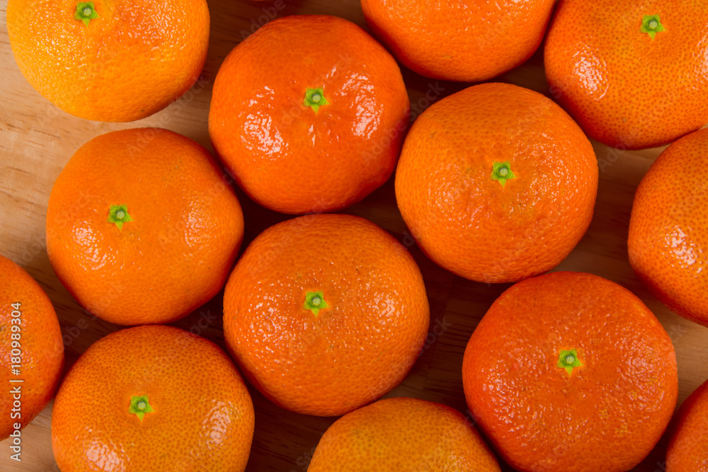 Group of fresh orange clementine on wood table background top view