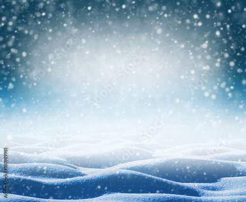 Winter bright background. Christmas background with snowdrifts and falling snow