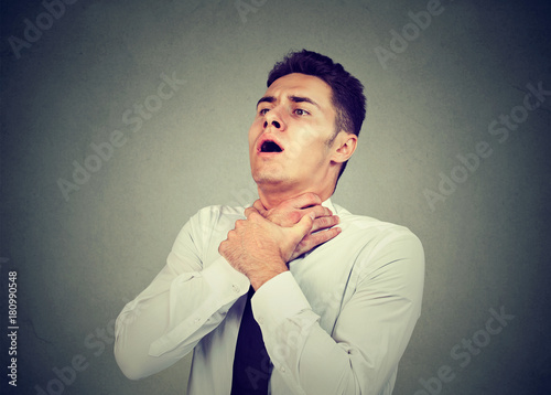 Cuadro en lienzo Young man having asthma attack or choking can't breath suffering from respiratio