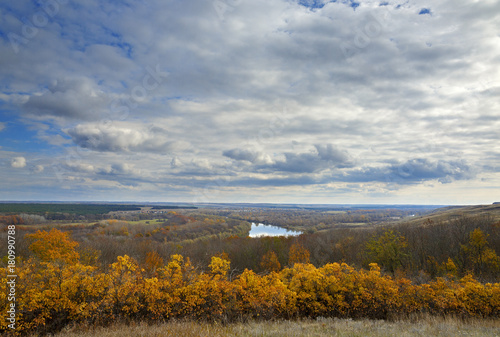 Autumn landscape on the hills of the River Don. View of the pond on a background of cloudy sky ..