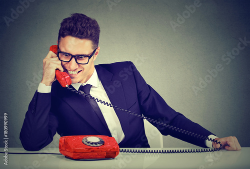 Pushy salesman business man advertising his best product on a phone