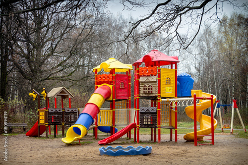 Deserted Playground in city Park in late autumn.