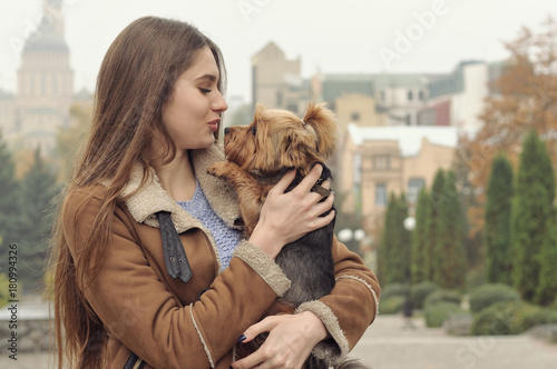 Canvastavla Girl holds a small dog in her arms, hugs and kisses her