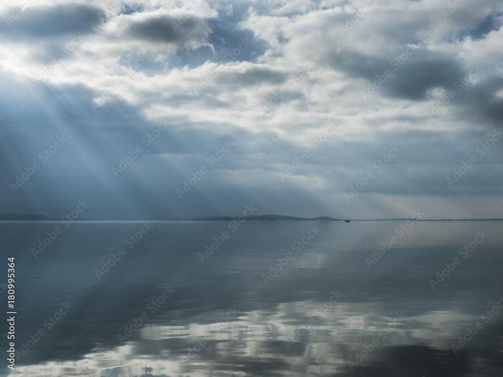 Sunburst on the lake with reflections