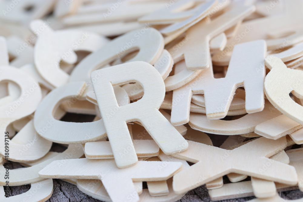 Letters of the English wooden alphabet. Creative education backdrop composition. For background and design. Close up and blur.