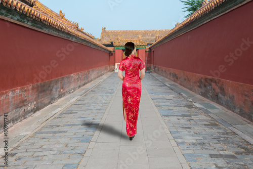 Asian young woman in old traditional Chinese dresses in the Forbidden city in Beijing, China.