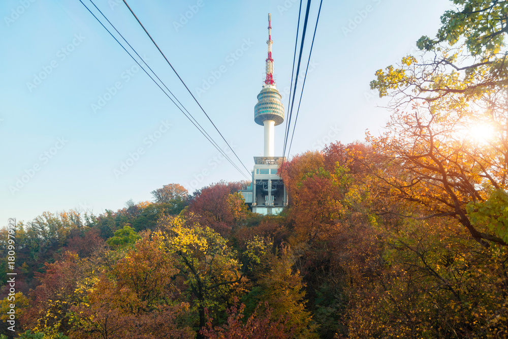 Namsan N Seoul Tower with the line of cable car at the sunset time in autumn at Seoul, South Korea.